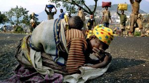 A Rwandan woman collapses with her baby on her back on the road near Goma, Zaire, in 1994. Many Rwandans fled across the border into what was then Zaire, now known as the Democratic Republic of Congo.