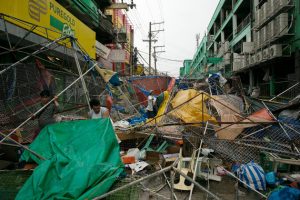 People clear the wreckage and debris of street stalls at a bazaar after Typhoon Mangkhut in Tuguegarao, Cagayan province, the Philippines, on Saturday, Sept. 15, 2018. Super Typhoon Mangkhut battered the Philippines with gales and torrential rains, leaving at least three people dead and thousands homeless, triggering landslides and damaging an airport before heading toward China. Photographer: Carlo Gabuco/Bloomberg via Getty Images